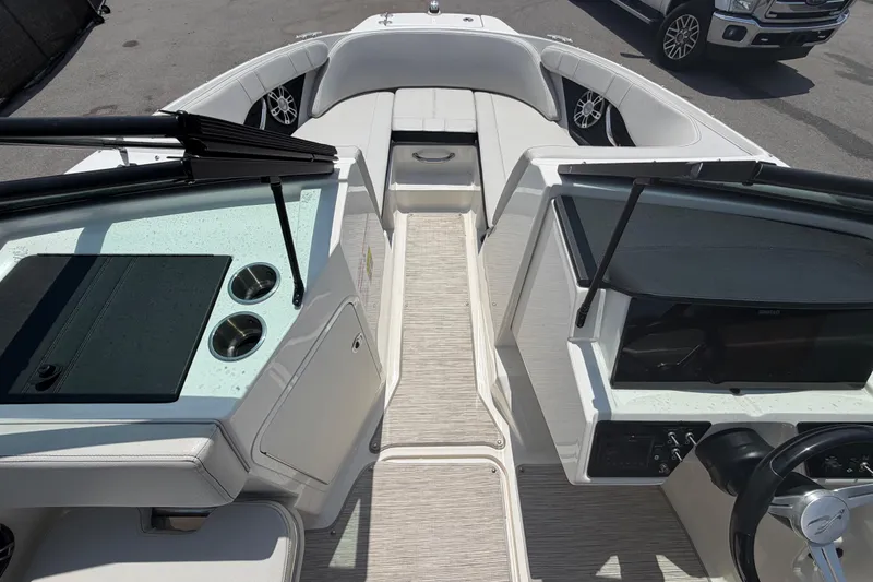 Slide: The Image of 2023 Sea Ray SPX 210 Outboard boat interior with sleek seating and modern dashboard. - 24