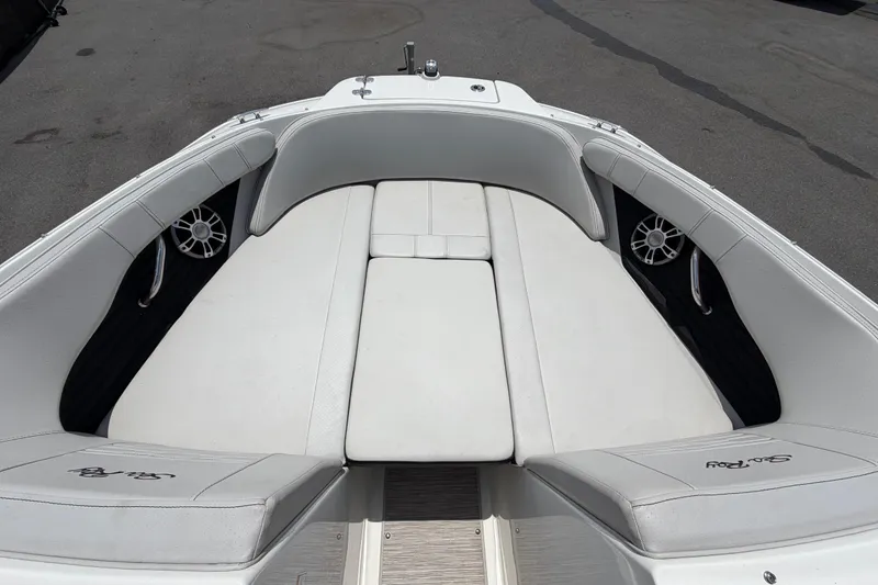 Slide: The Image of 2023 Sea Ray SPX 210 Outboard boat interior with white cushioned seating. - 36
