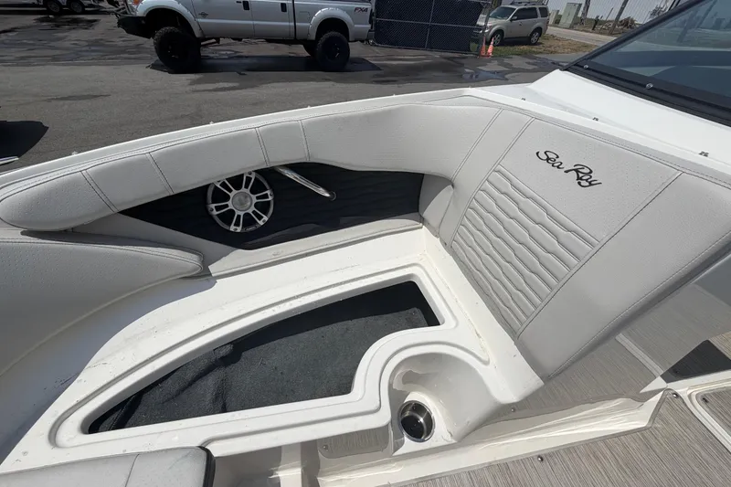 Slide: The Image of 2023 Sea Ray SPX 210 Outboard boat interior with white seating and speaker. - 33