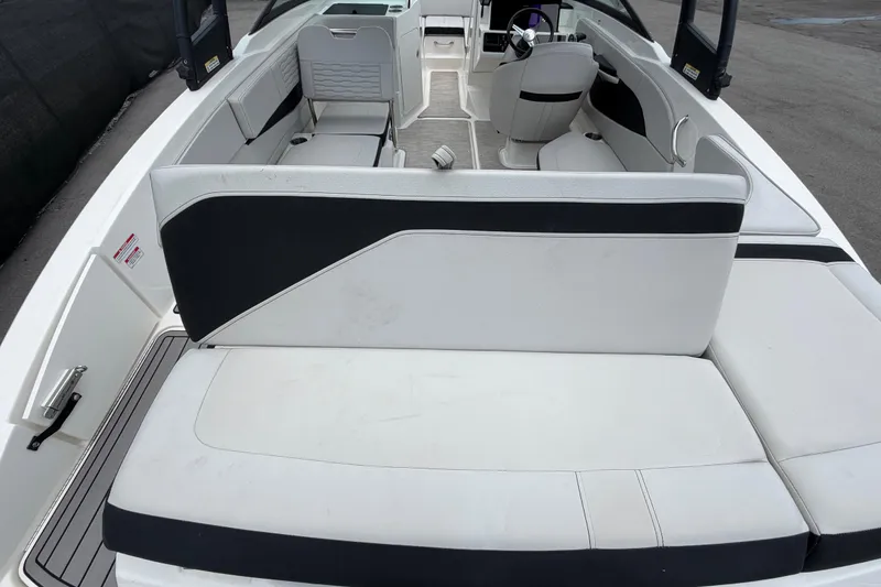 Slide: The Image of 2023 Sea Ray SPX 210 Outboard boat interior with white and black seating. - 13