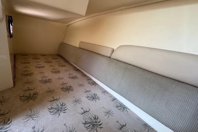 Slide: The Image of 2008 Scout 295 Abaco cabin interior with patterned carpet and cushioned seating. - 28