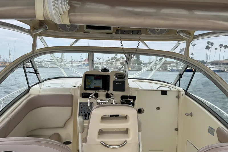 Slide: The Image of 2008 Scout 295 Abaco boat cockpit with steering wheel and navigation system. - 11