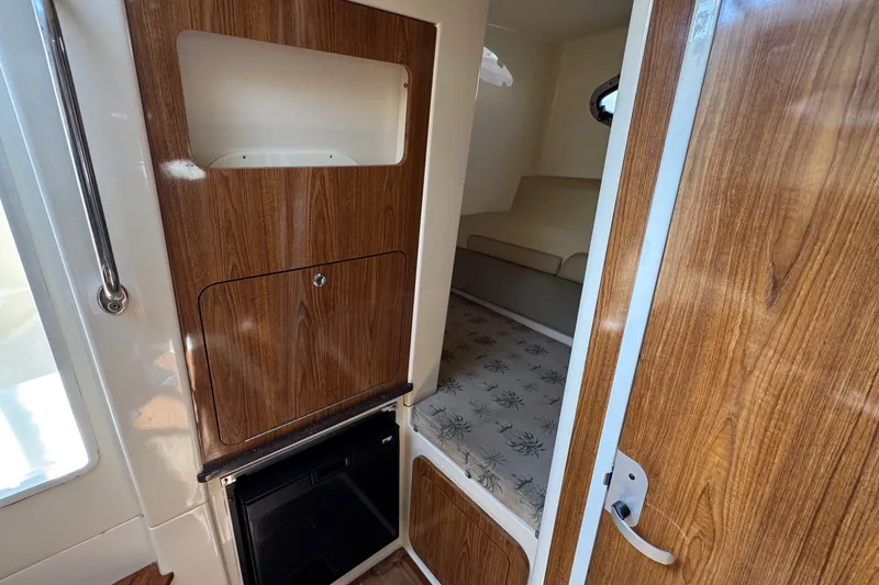 Slide: The Image of 2008 Scout 295 Abaco cabin interior with wood paneling and seating area. - 29