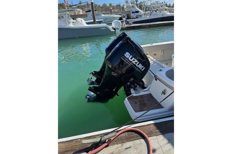 Slide: The Image of 2008 Scout 295 Abaco with Suzuki outboard motor docked in marina. - 4
