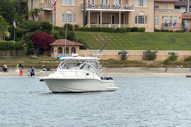 Slide: The Image of 2008 Scout 295 Abaco boat on water near elegant waterfront mansion. - 3