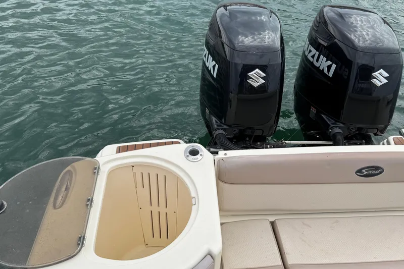Slide: The Image of 2008 Scout 295 Abaco boat with twin Suzuki outboard motors on water. - 14