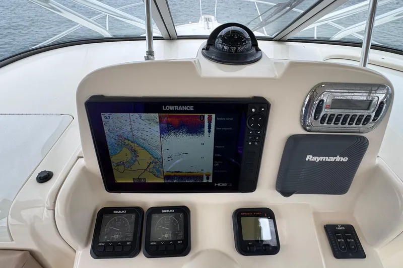 Slide: The Image of Dashboard of a 2008 Scout 295 Abaco boat with navigation and control instruments. - 8