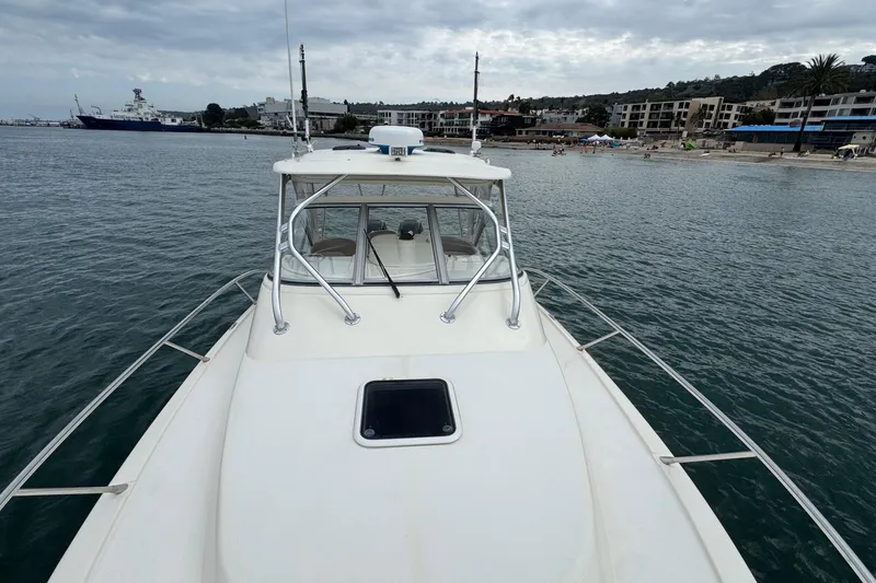 Slide: The Image of 2008 Scout 295 Abaco boat on calm water near a coastal town. - 15