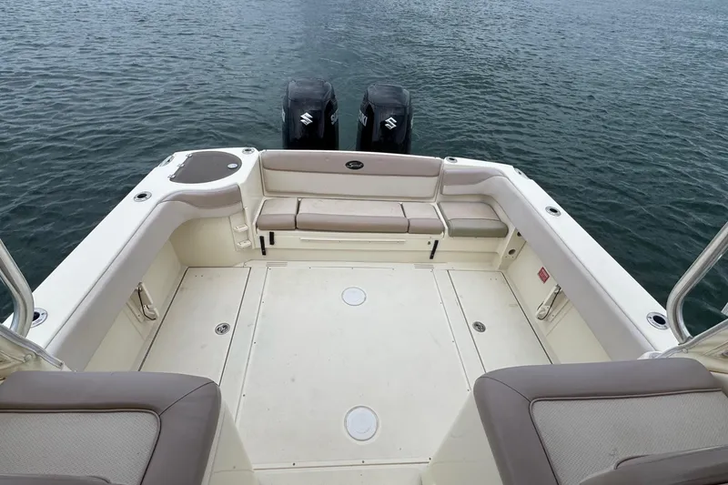 Slide: The Image of 2008 Scout 295 Abaco boat deck with seating and twin outboard motors on water. - 23