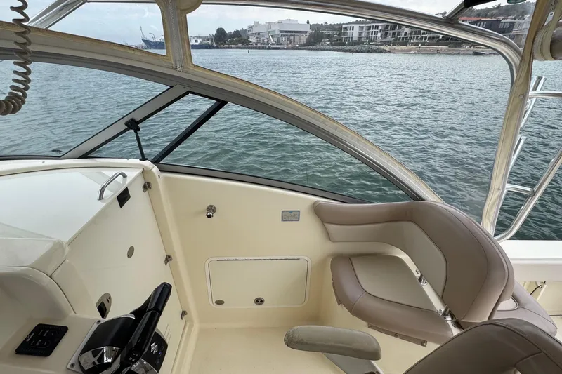 Slide: The Image of Interior view of 2008 Scout 295 Abaco boat cockpit with water and shoreline in background. - 6