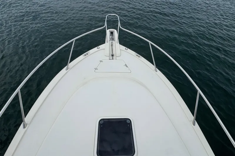 Slide: The Image of Bow view of 2008 Scout 295 Abaco boat on calm water. - 16
