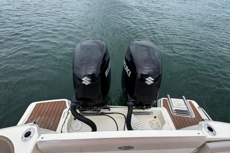 Slide: The Image of 2008 Scout 295 Abaco boat with dual Suzuki outboard motors on water. - 20