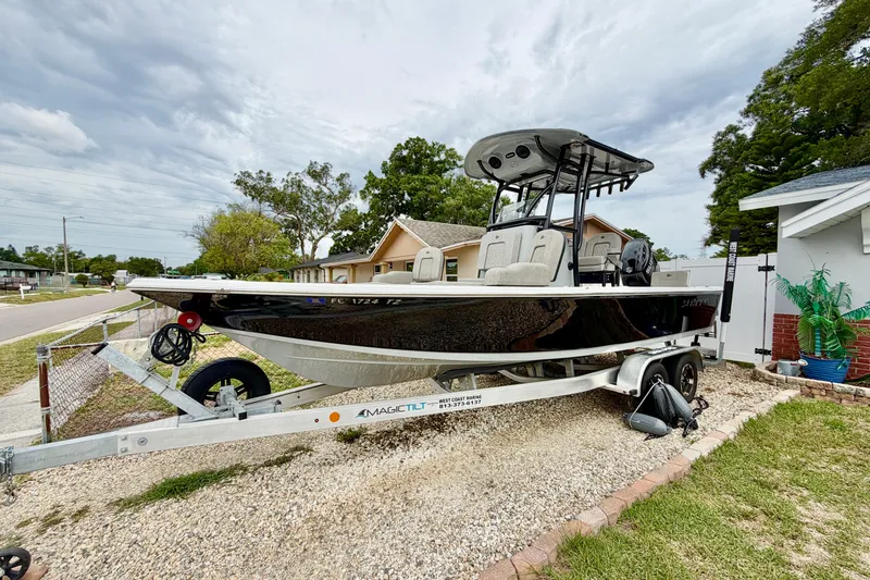 The Image of 2025 Sea Pro 230 Bay boat on trailer in residential driveway. - 0