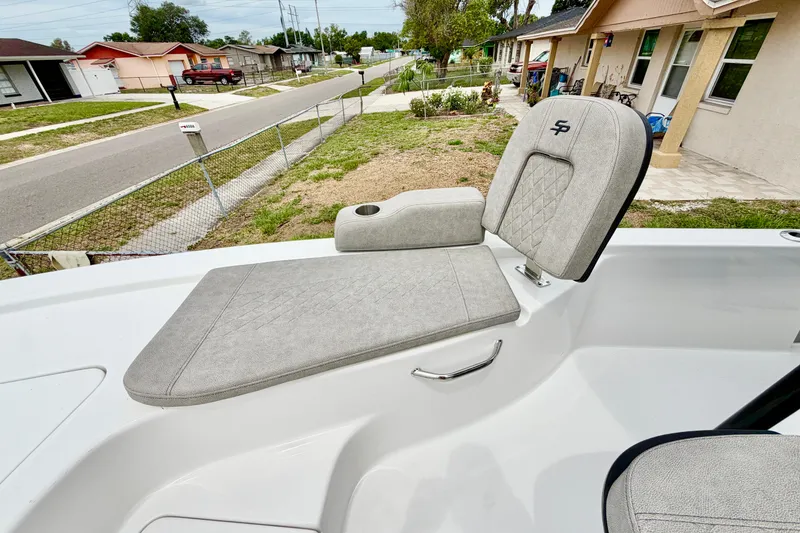 Slide: The Image of 2025 Sea Pro 230 Bay boat seat with diamond-pattern upholstery in a residential area. - 11