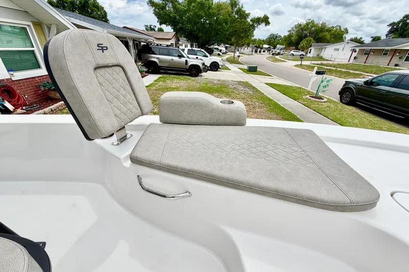 Slide: The Image of 2025 Sea Pro 230 Bay boat seat with gray upholstery in a residential neighborhood. - 13