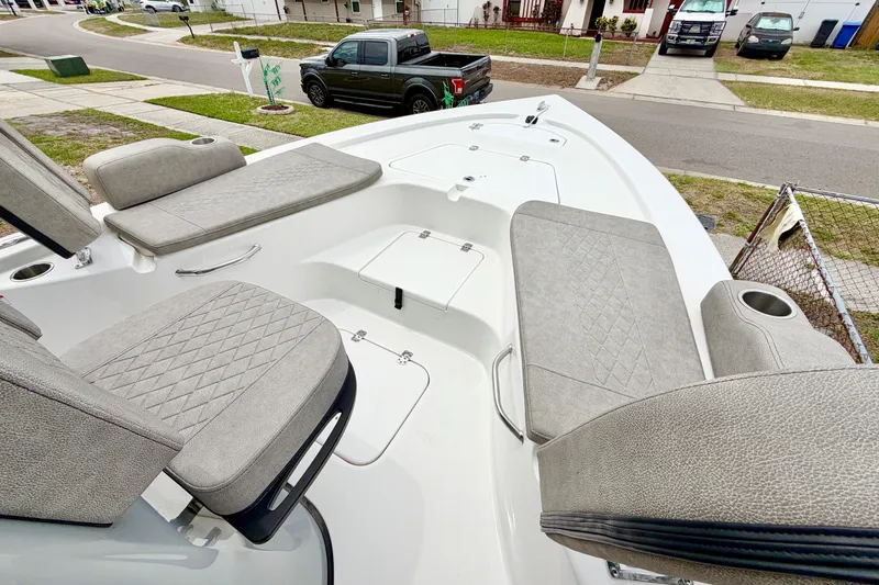 Slide: The Image of 2025 Sea Pro 230 Bay boat interior with cushioned seating and storage compartments. - 14