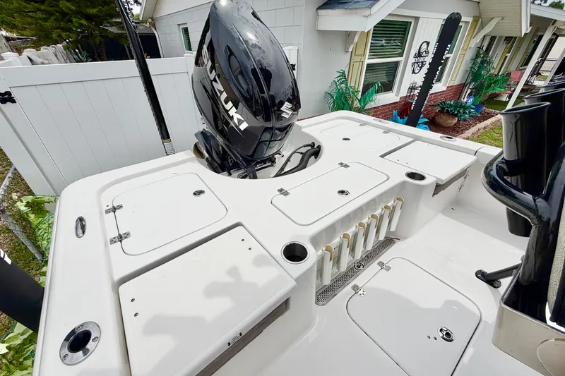 Slide: The Image of 2025 Sea Pro 230 Bay boat deck with Suzuki outboard motor, featuring storage compartments. - 3