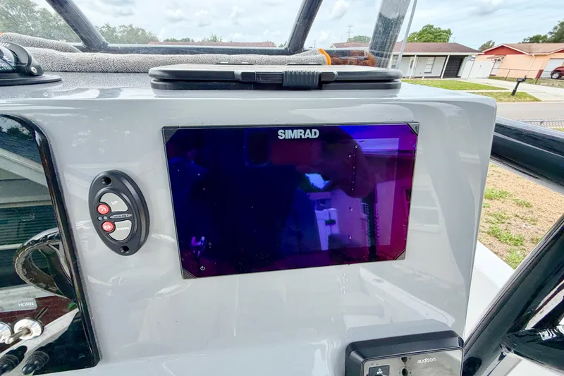 Slide: The Image of 2025 Sea Pro 230 Bay boat dashboard with Simrad display and control panel. - 6