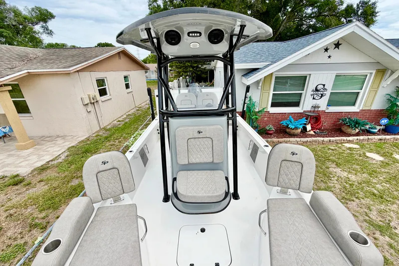 Slide: The Image of 2025 Sea Pro 230 Bay boat with seating, parked in a residential yard. - 9