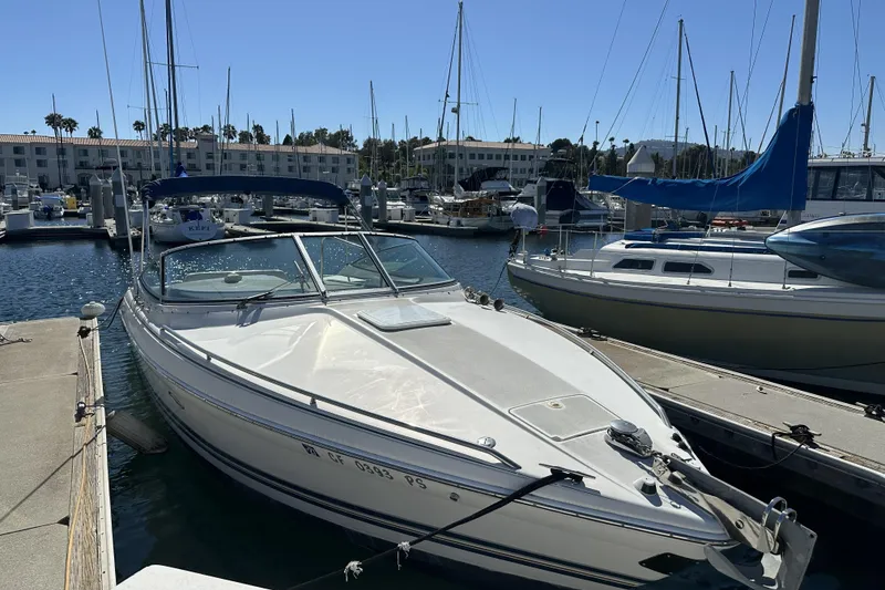 Slide: The Image of Boat docked at a marina with other sailboats in the background. - 10