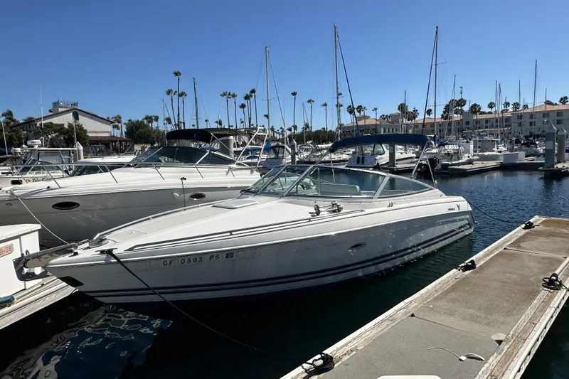 The Image of 2000 Formula 280 Sun Sport boat docked in a marina under clear blue skies. - 0