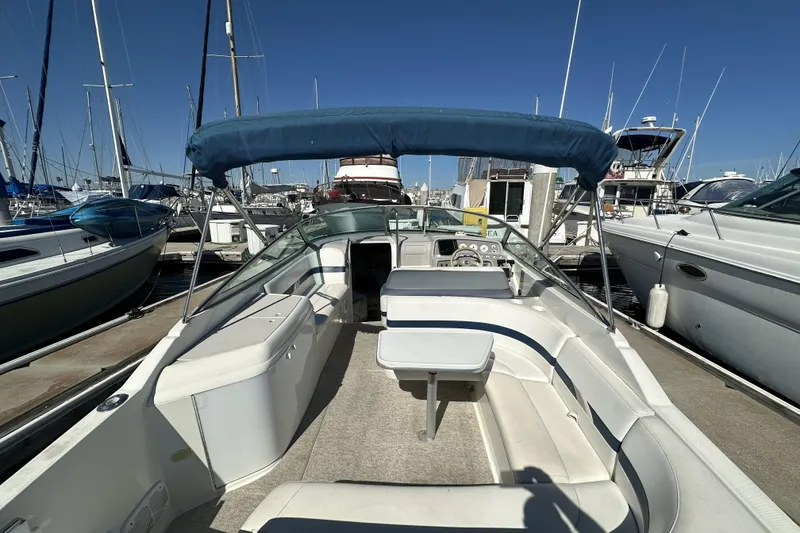 Slide: The Image of 2000 Formula 280 Sun Sport boat docked at marina with blue canopy. - 6