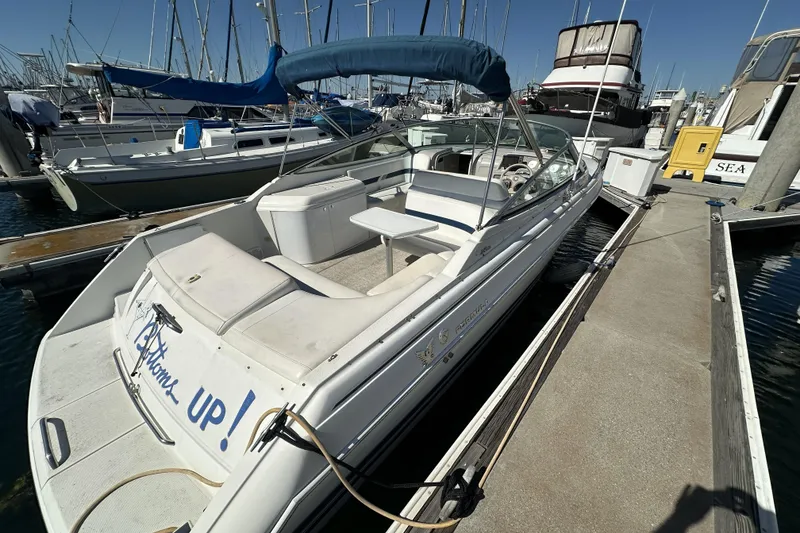 Slide: The Image of 2000 Formula 280 Sun Sport boat docked at marina, featuring sleek design and comfortable seating. - 4