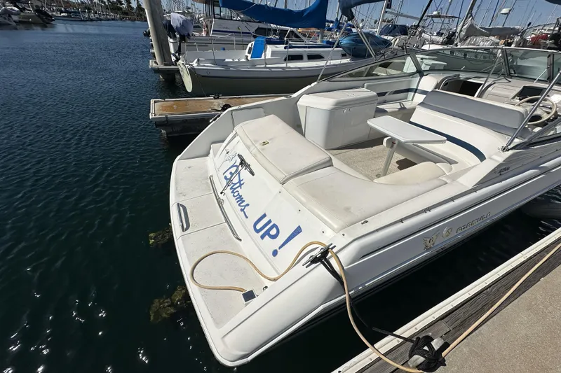 Slide: The Image of 2000 Formula 280 Sun Sport boat docked in marina, featuring spacious seating and clean design. - 5