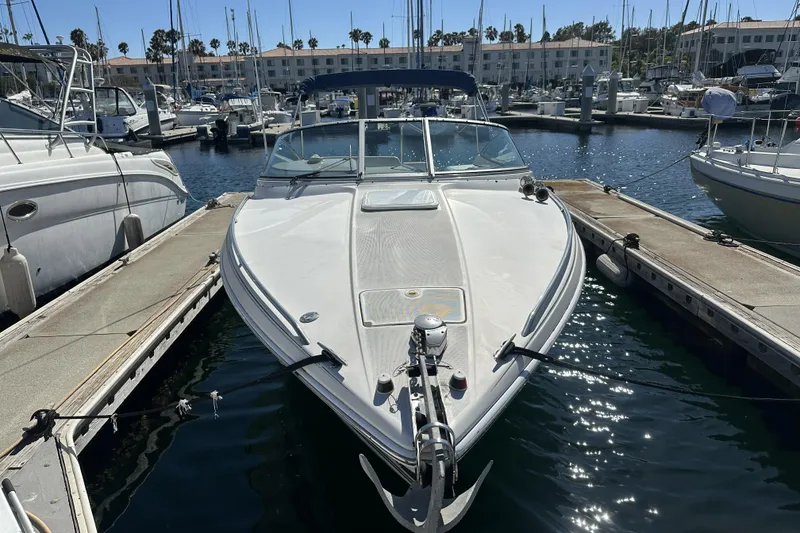 Slide: The Image of 2000 Formula 280 Sun Sport boat docked in a marina under clear skies. - 2