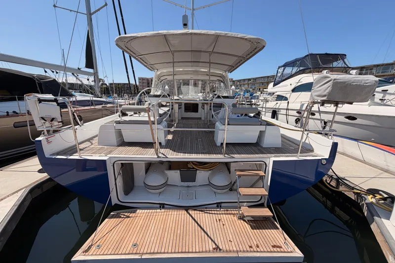 Slide: The Image of 2022 Beneteau Oceanis Yacht 54 docked, showcasing spacious deck and modern design. - 11