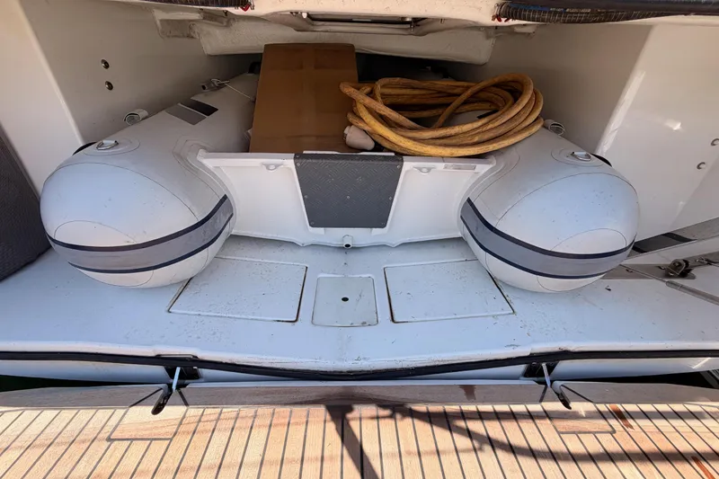 Slide: The Image of Storage compartment of 2022 Beneteau Oceanis Yacht 54 with inflatable dinghy and coiled rope. - 12