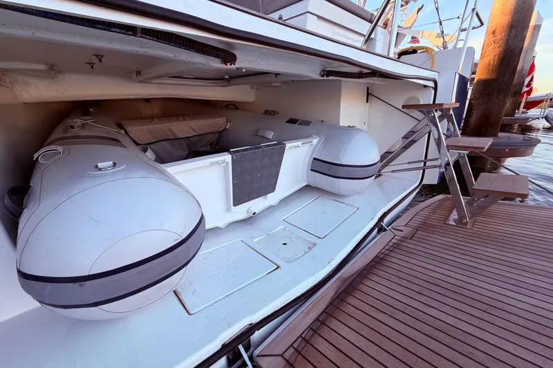 Slide: The Image of 2022 Beneteau Oceanis Yacht 54 with inflatable tender in storage compartment. - 13