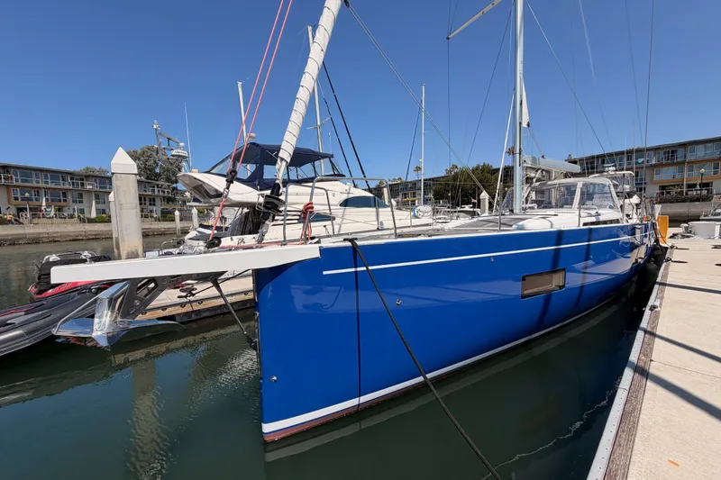 Slide: The Image of 2022 Beneteau Oceanis Yacht 54 docked, featuring sleek blue hull and modern design. - 4