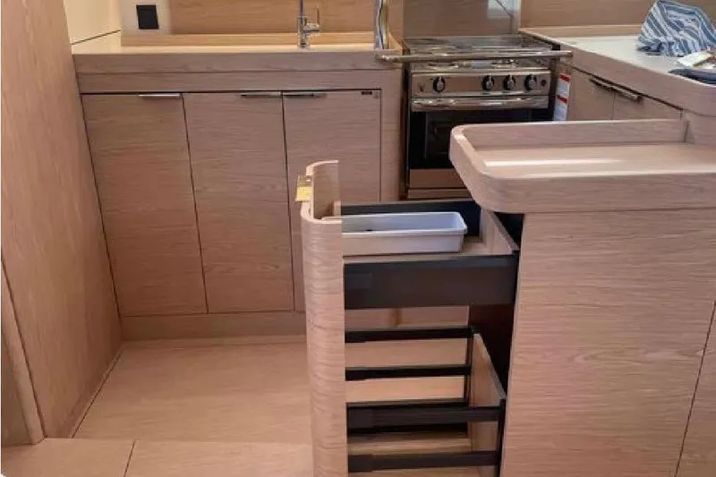 Slide: The Image of Modern kitchen interior of 2022 Beneteau Oceanis Yacht 54 with sleek cabinetry and appliances. - 48