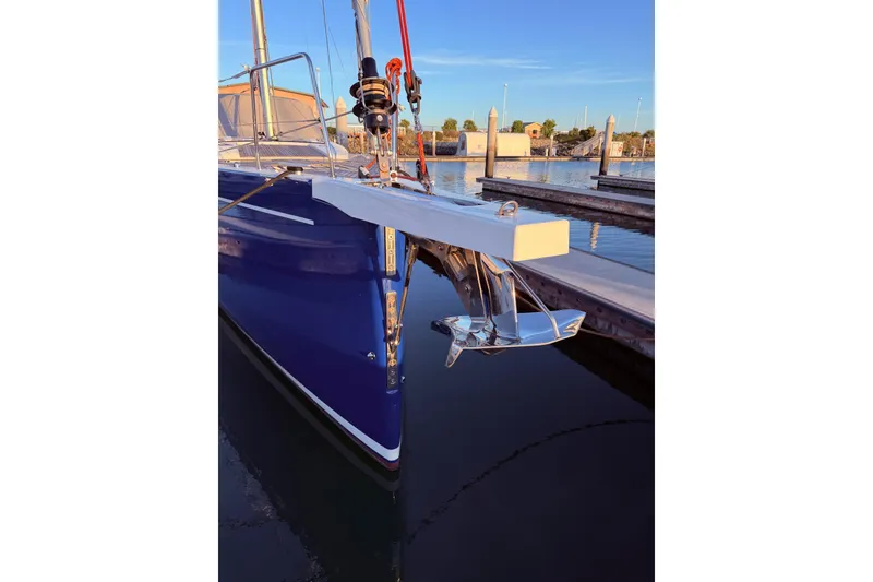 Slide: The Image of Beneteau Oceanis Yacht 54, 2022 model, docked with visible anchor and sleek blue hull. - 5