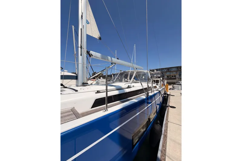 Slide: The Image of 2022 Beneteau Oceanis Yacht 54 docked, showcasing sleek blue hull and modern design. - 7