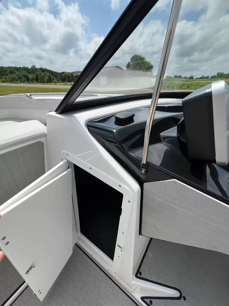 Slide: The Image of Interior view of a Yamaha SX250 boat with an open storage compartment and helm console. - 11