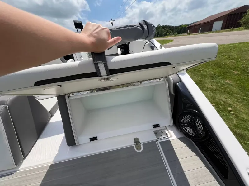 Slide: The Image of A person opens a storage compartment on a 2023 Yamaha SX250 boat. - 23