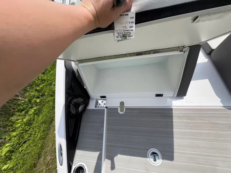 Slide: The Image of An open storage compartment on a 2023 Yamaha SX250 boat. - 22