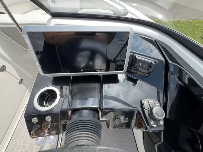 Slide: The Image of The image shows the cockpit of a 2023 Yamaha SX250 boat with a modern helm console. - 18