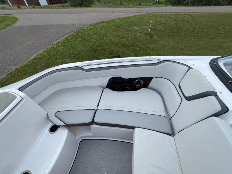 Slide: The Image of The image shows the seating area of a 2023 Yamaha SX250 boat with white upholstery. - 9