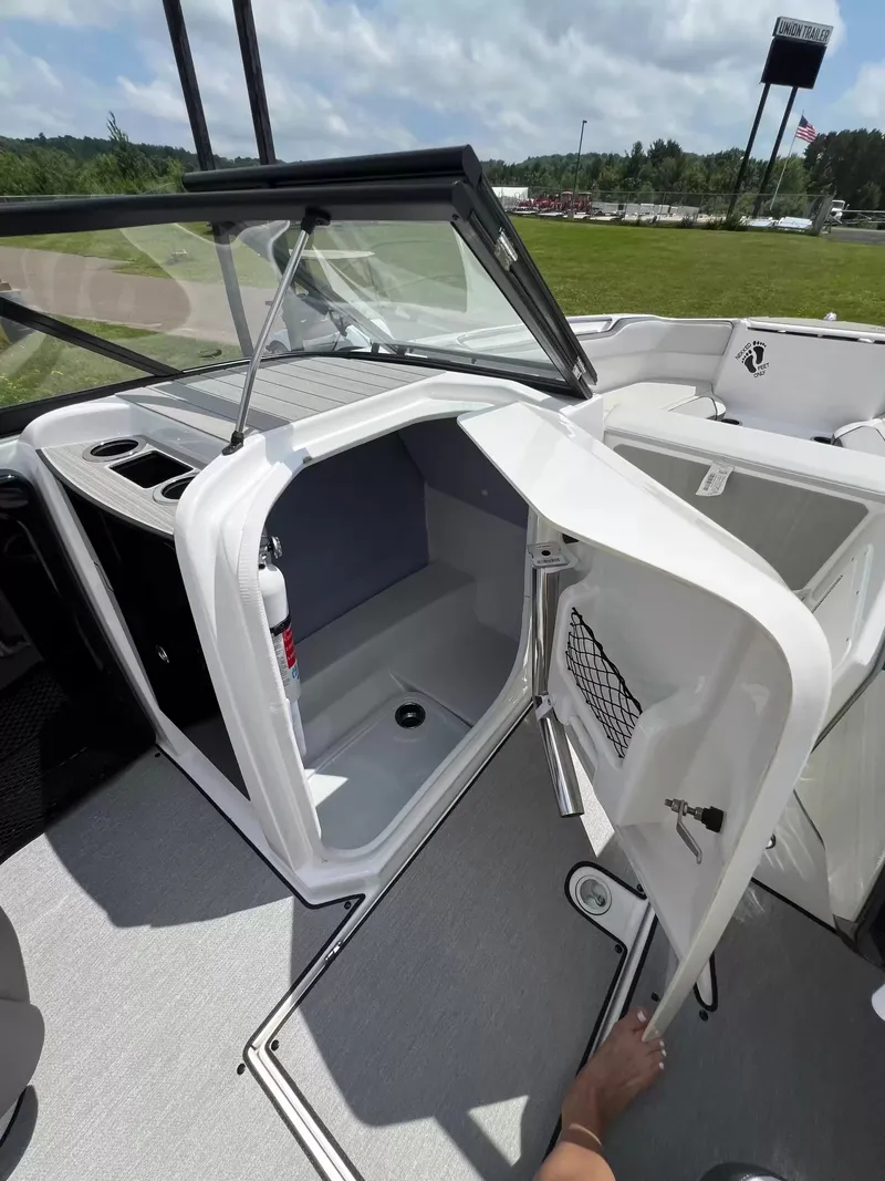 Slide: The Image of The image shows the interior of a 2023 Yamaha SX250 boat with storage space and a fire extinguisher. - 14