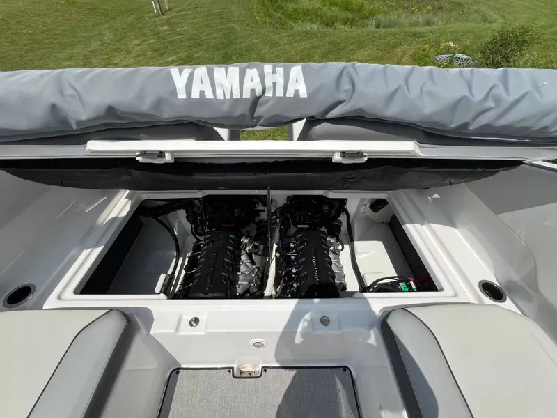 Slide: The Image of Engine compartment of a Yamaha SX250 boat with twin engines, surrounded by gray upholstery. - 27