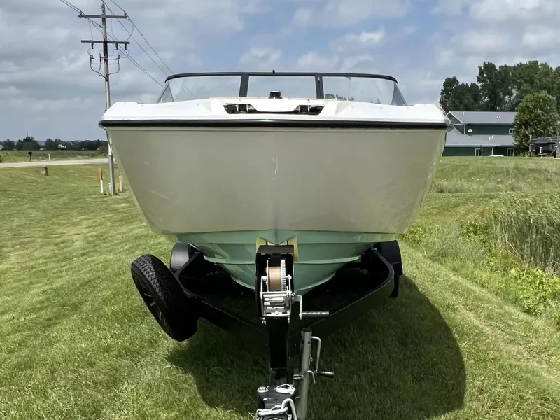 Slide: The Image of A 2023 Yamaha SX250 boat on a trailer, positioned on a grassy field. - 3