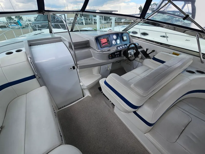 Slide: The Image of The cockpit of a 2001 Formula 400 Super Sport with white seating and a modern helm. - 11