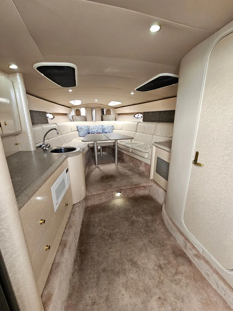 Slide: The Image of Interior of a 2001 Formula 400 Super Sport with kitchenette, seating area, and table. - 12