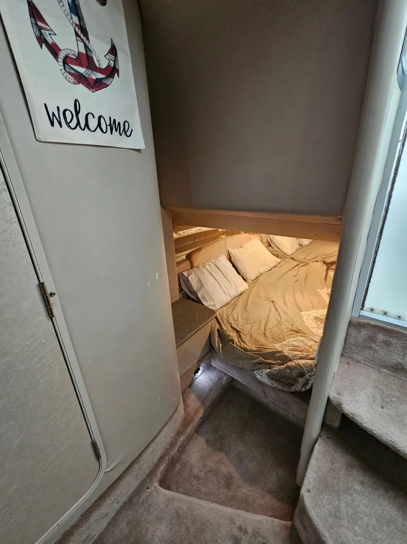 Slide: The Image of Interior of a boat cabin with a cozy bed and a "Welcome" sign. - 14