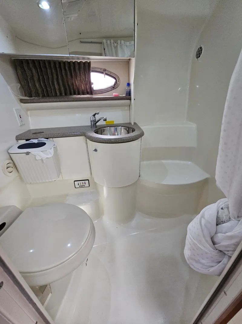 Slide: The Image of The image shows the bathroom of a 2001 Formula 400 Super Sport yacht with a sink and toilet. - 16