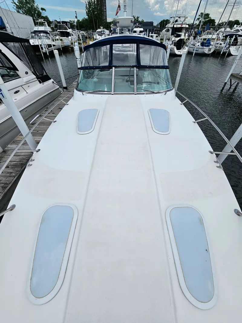 Slide: The Image of A white motor yacht docked in a marina, surrounded by other boats. - 3