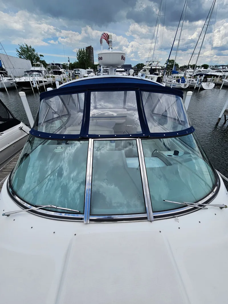 Slide: The Image of A 2001 Formula 400 Super Sport docked in a marina, surrounded by other boats. - 4